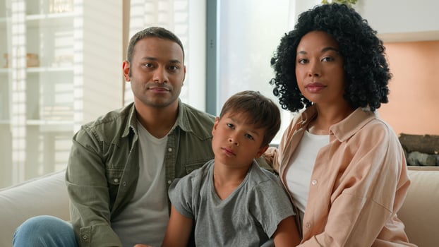 African American mother and father loving mum dad family portrait multiracial couple parents and Caucasian adopted child kid looking at each other smiling hug adorable cute little boy son childcare photo