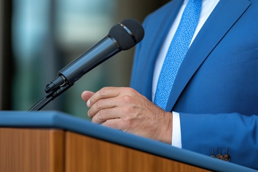 close up of speaker's hand giving speech at podium photo