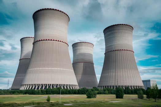 Nuclear power plant cooling towers dominating landscape photo