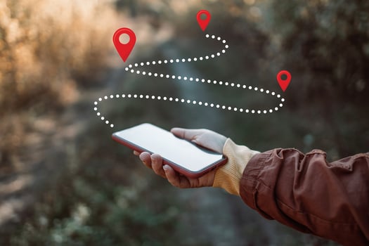 Woman consulting smartphone in the forest to avoid getting lost. Travel and adventure concept photo