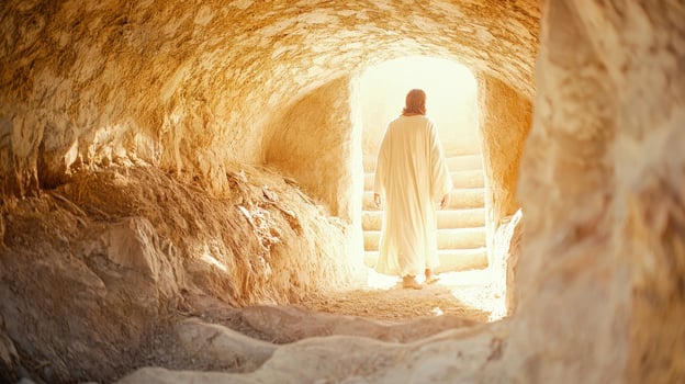 Happy Easter Jesus Christ is walking out of his tomb after the resurrection, in bright sunlight photo