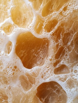 Abstract background of foamy liquid with golden hues photo