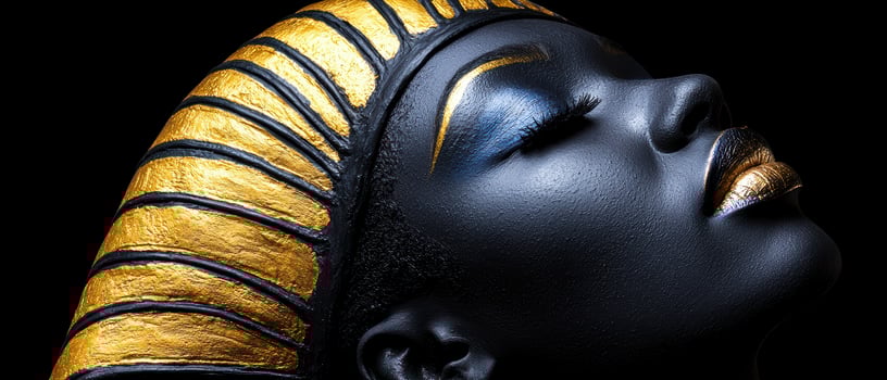 Close up of a womans face with gold and black makeup, wearing a gold and black headdress photo