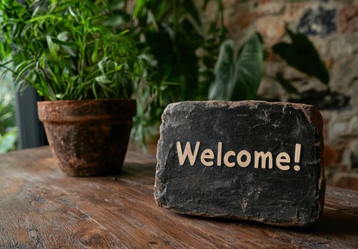 Welcome sign on rustic wooden table with plants photo