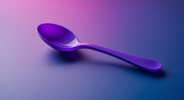 Purple Plastic Spoon on a Gradient Background photo