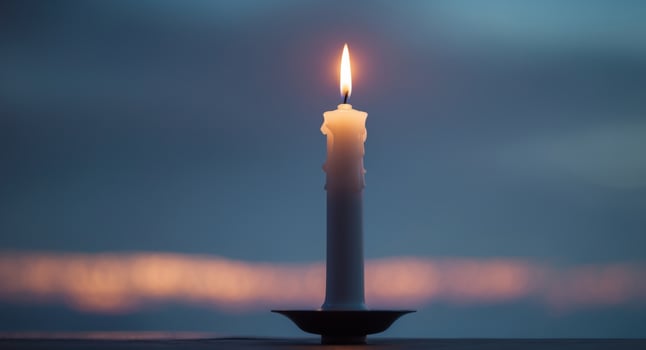 Vivid Single Candle Illuminating Darkness A Beacon of Hope in Solitude at Twilight photo