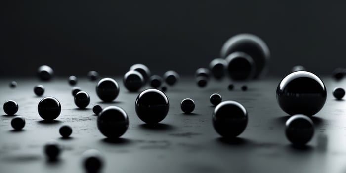 Black spheres rolling on a dark surface creating a dramatic scene photo