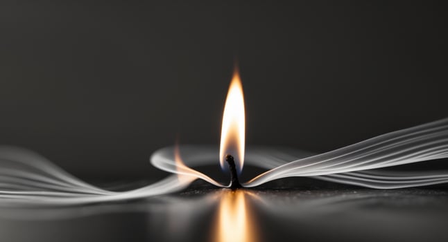Candle Flame Close Up Flickering on Reflective Surface. photo
