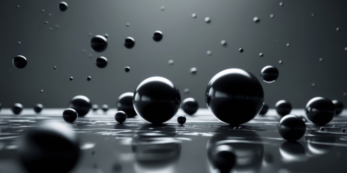 Black spheres rolling on a dark surface creating a dramatic scene. photo