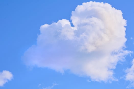 Big cloud on light bright blue peaceful sky photo