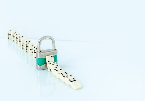 Padlock stopping domino effect on white background. photo