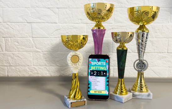 Win on sports betting, online bookmaker service. golden trophy cup, mobile phone. Banner design photo