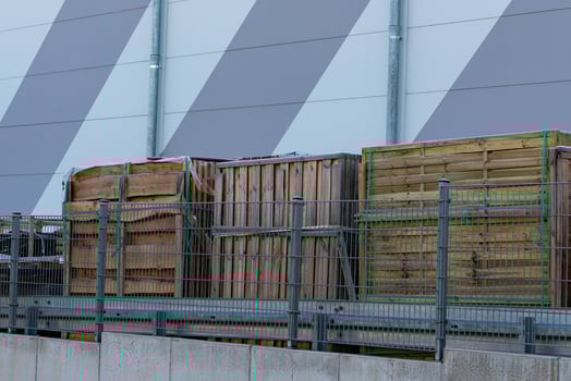 Wooden crates stacked against a gray wall with industrial design photo
