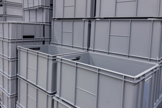Grey storage containers stacked at a warehouse location photo