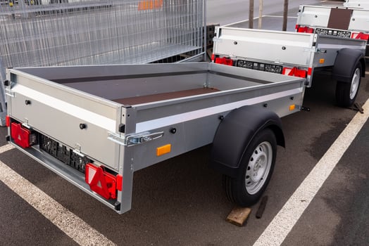 Cargo trailers for passenger car parked in a spacious lot photo