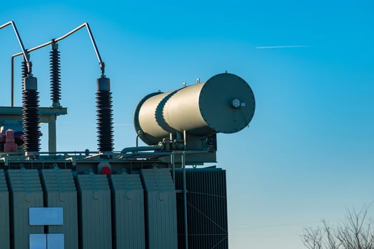 High voltage transformer equipment against clear blue sky photo