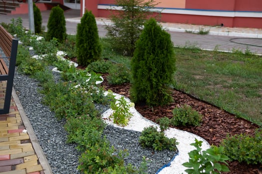 Landscape design in green gnoramic view of nice landscaped yard of residential house. Paving path, plants and vintage lantern in home backyard, beautiful landscaping in summer. photo