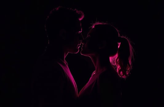 Pink Silhouette Couple Man and Woman Behind on Black Background photo