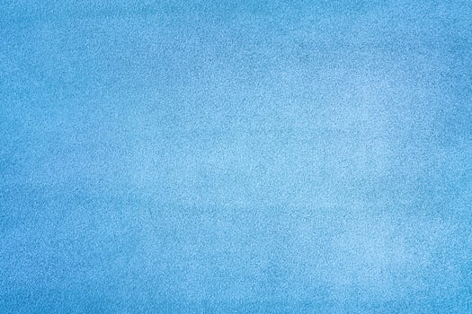 Light blue suede leather as a background macro photo. photo