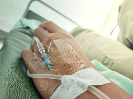 Close-Up of Patient's Hand Receiving Intravenous Drip in Hospital photo