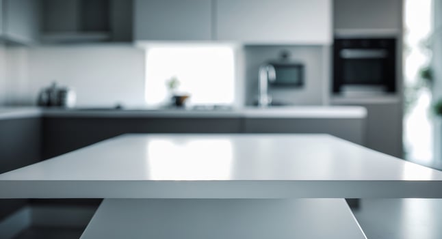 Empty white table in modern kitchen setting with blurred background photo