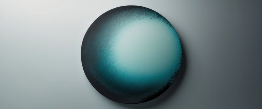 Round gradient with a rough texture going from blue green to charcoal on a see through background photo