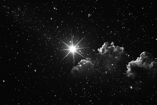 A black and white photo of a star and clouds