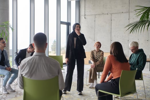 Corporate business team meeting with a manager or coach. Group of happy diverse, multiracial people sitting in a circle photo