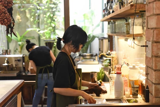Vietnamese waitress getting ready an order in a coffee shop photo