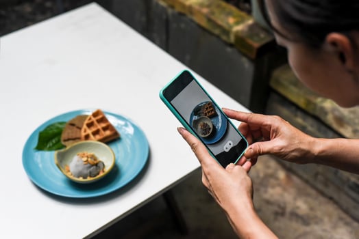 A woman taking picture of ice cream for advertisement and social media photo