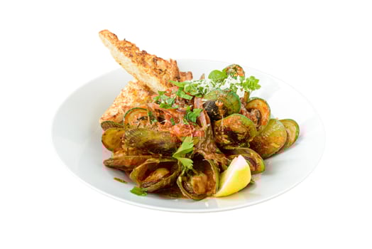 A plate of mussels with bread and a lemon wedge photo