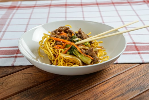 A bowl of noodles with meat and vegetables photo
