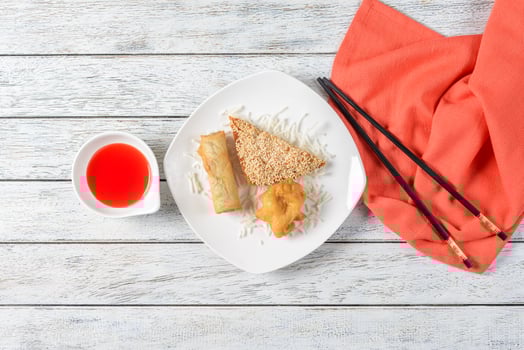 Chinese food on a plate with chopsticks and sauce photo