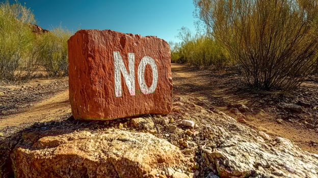 Red rock desert sign that says no photo