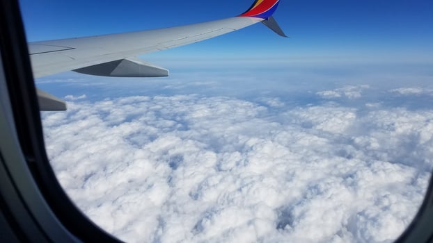 Flying above Puffy Clouds, View from the Plane Window photo
