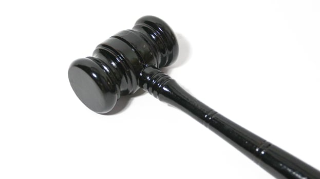 Wooden gavel isolated on white. Small mallet. photo