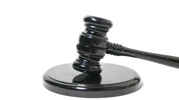 a black gavel on top of a white surface photo