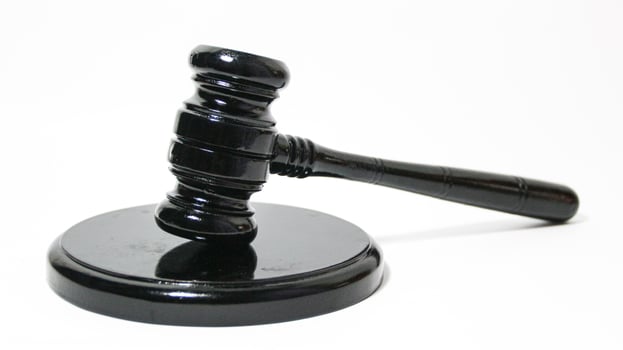 a black gavel on a white surface photo