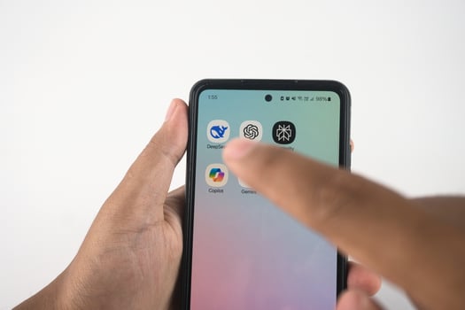 Hand Navigating Smartphone Apps Featuring AI-Themed Icons. Such as Deepseek, ChatGPT, Copilot, Gemini, and Perplexity photo