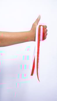 Hand Holding Red and White Ribbons Showing Thumb Up on White Background photo