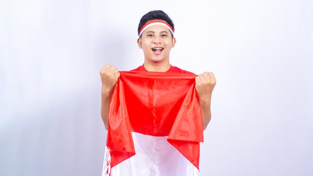 Indonesian Man Celebrating Independence Day of Indonesia on White Background photo