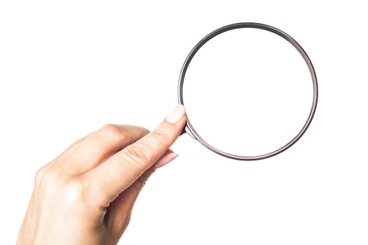 Hand holding magnifying glass isolated on white background photo