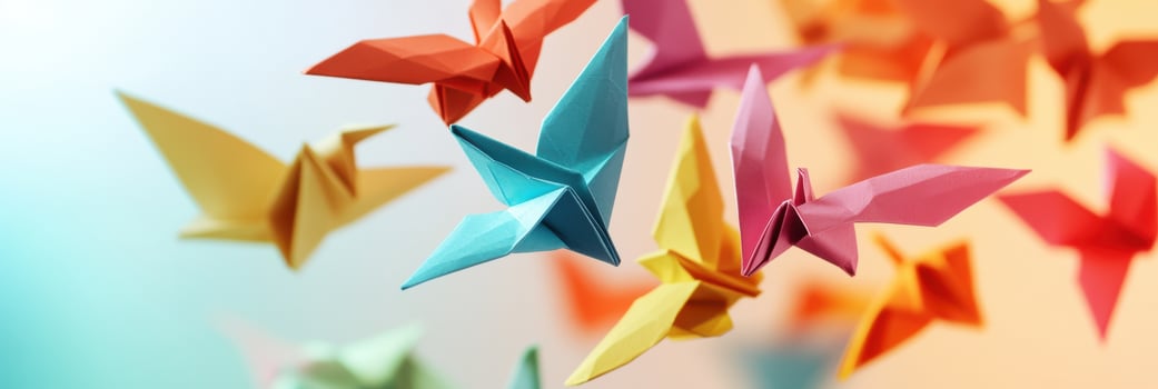 Vibrant origami paper cranes flying with colorful backgrounds in focus photo