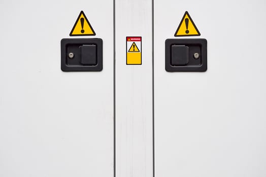 Metal doors with two locks, electric shock hazard sign zone photo