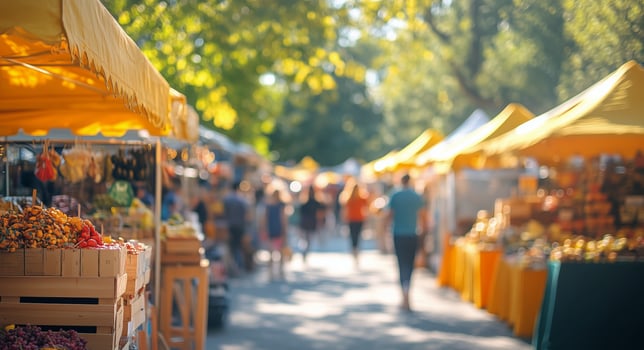 Vibrant outdoor market showcasing local produce and crafts in sunny weather photo