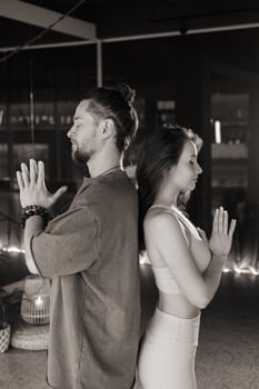 Meditation practice with a male and female yogi in a serene indoor space during evening hours promoting mindfulness and relaxation through yoga. Yoga photo