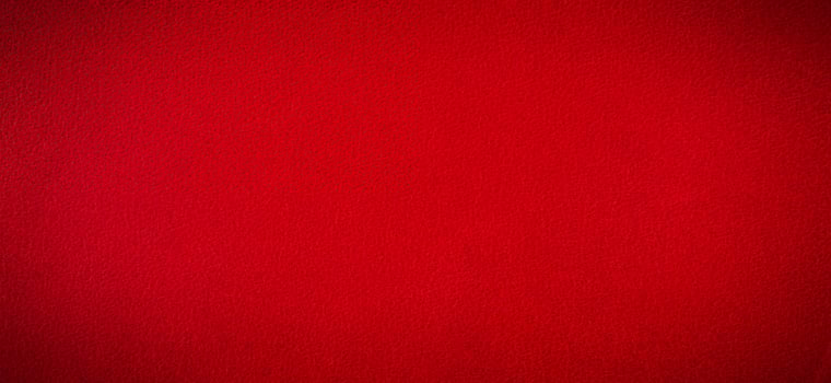 Red suede as a background with a vignette banner size. photo