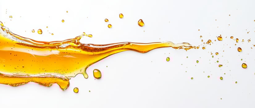 Drizzles of golden honey create intriguing splashes as they move across a white surface. The liquid forms captivating shapes and highlights the natural viscosity and color of honey. photo