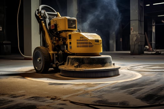 Floor buffing machine smoothing concrete surface in warehouse photo