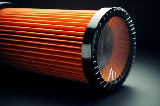New orange car air filter wrapped in plastic on dark background photo